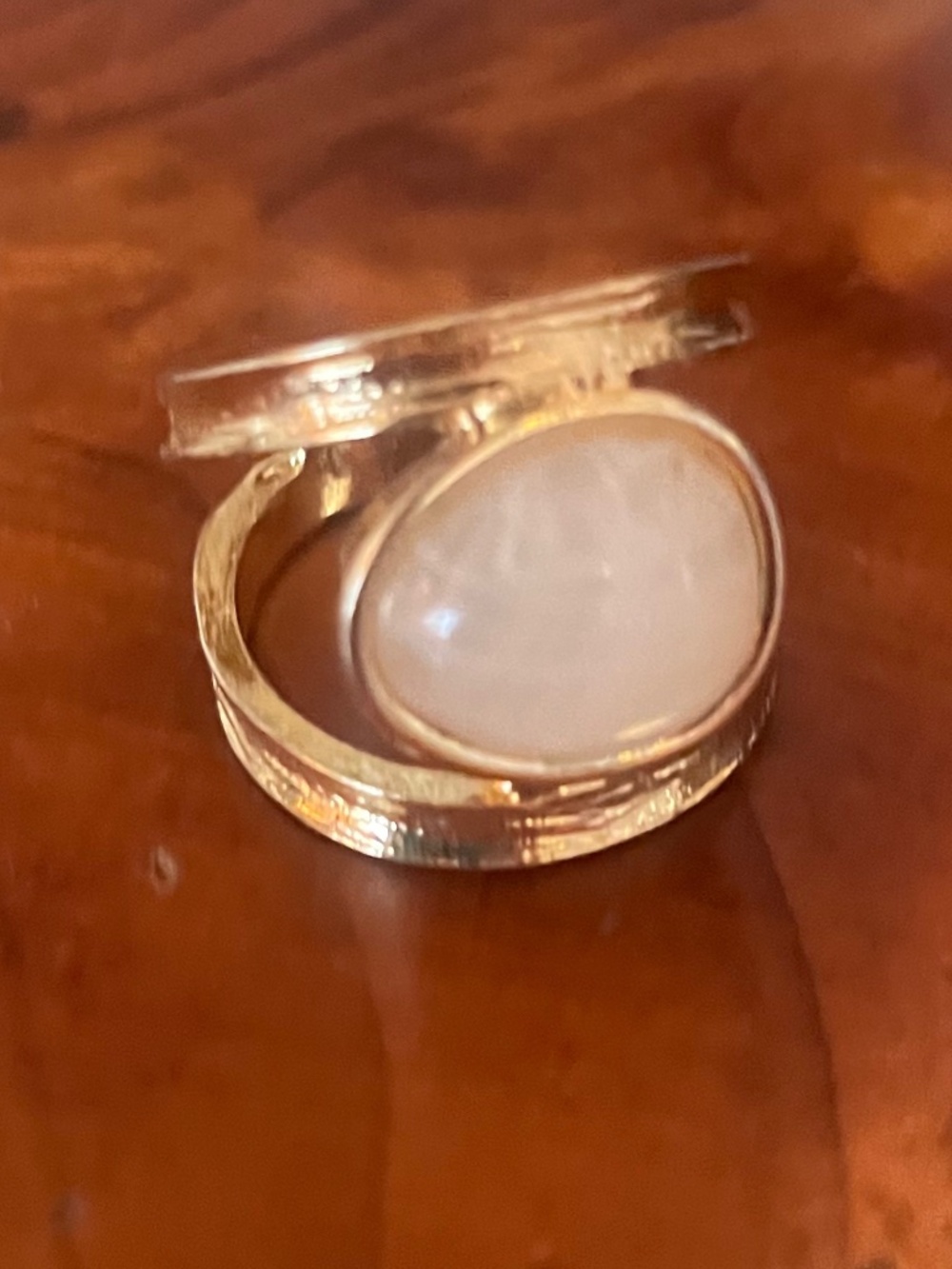 Gold-plated ring features a unique cabochon-cut gemstone